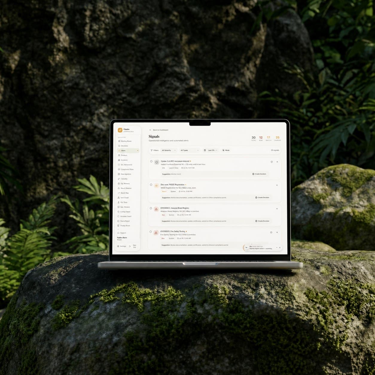 The current FinFlow build: a Signals dashboard listing operational alerts like overdue compliance tasks and inventory movement, open on a laptop